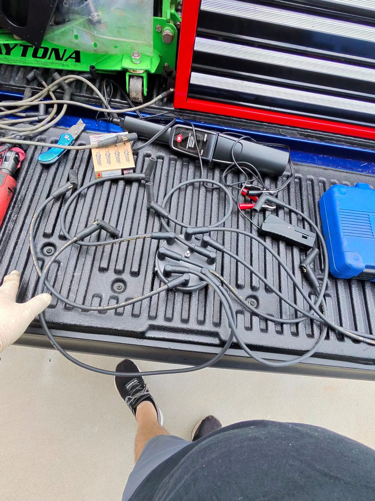 Test leads, clamps and a meter laid out on a truck tailgate during electrical testing